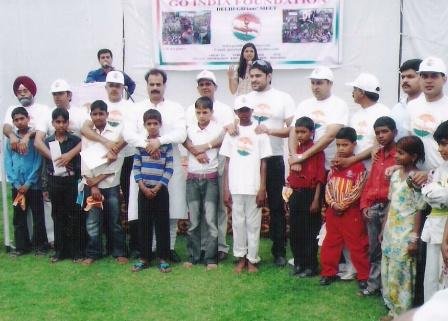 J.s Nayol poses for a group and group photograph with needy and orphan children at a function
